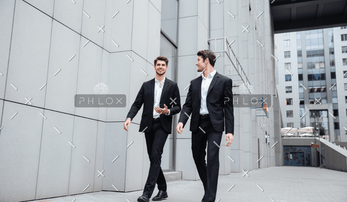 demo-attachment-922-two-businessmen-walking-and-talking-in-the-city-PMW8E26